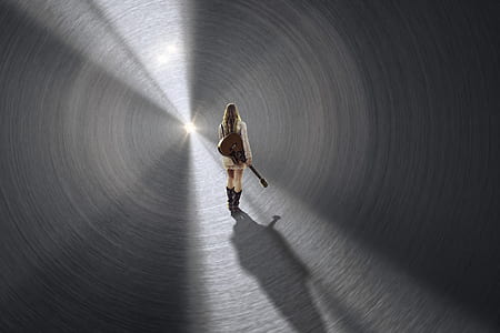 woman holding brown acoustic guitar thumbnail