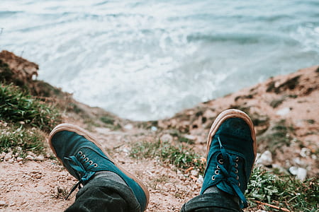 person lying on cliff over body of water thumbnail