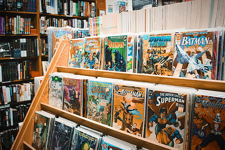 pile of comic books on wooden rack thumbnail