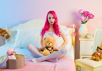 woman with pink hair and brown bear plush toy ] thumbnail