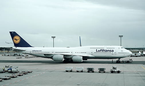 Lufthansa plane beside trucks thumbnail