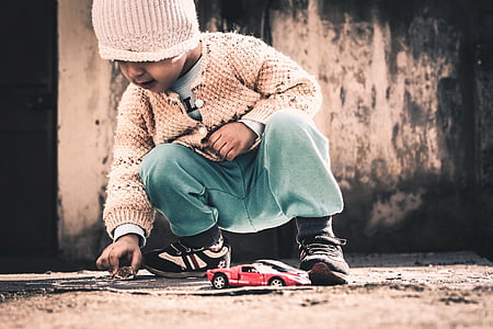 girl playing red car toy thumbnail