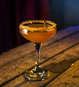 Clear Liquor Glass With Orange Liquid thumbnail