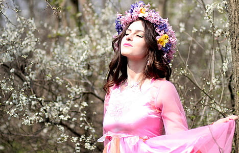 woman in pink standing near on tree thumbnail