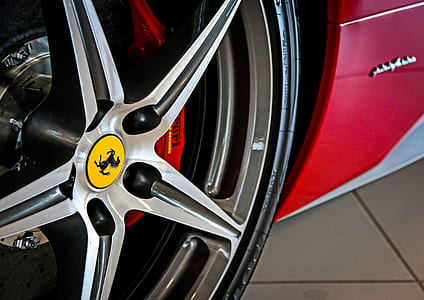 gray Ferrari 5-spoke vehicle wheel and tire in close-up photo thumbnail