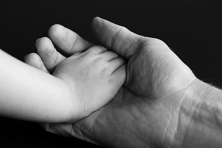 grayscale photo of hand of baby on adult palm thumbnail