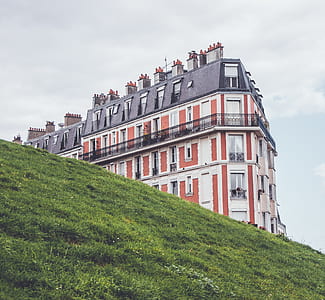 red and white mansion near grass field thumbnail