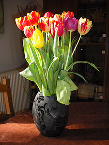 selective focus photography of red and yellow tulips flower on gray vase thumbnail