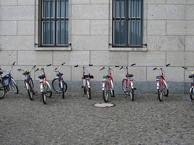 bicycles parked near wall during daytime thumbnail