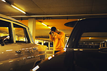 man standing beside car thumbnail