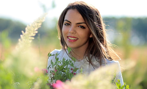 selective focus photography of woman with white crew-neck shirt during daytime thumbnail