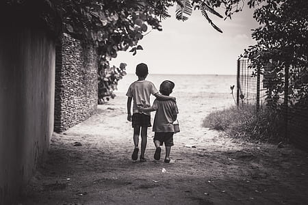 two boys walking on pathway thumbnail