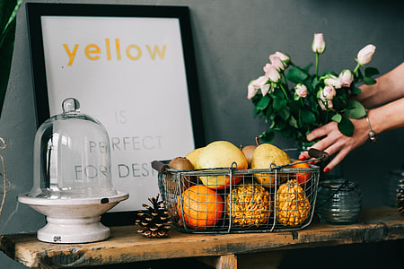Assorted accessories with flowers and fruit on a shelf thumbnail
