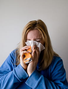 woman blowing her nose on tissue thumbnail