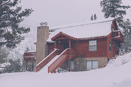 snow covered brown house under gray sky at daytime thumbnail