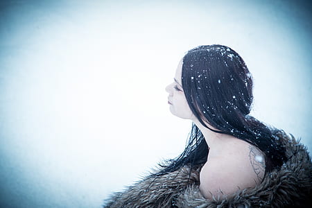 woman wearing brown fur coat with snow on hair thumbnail