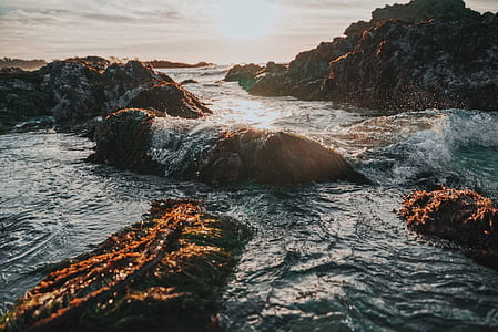 body of water splashing rock thumbnail
