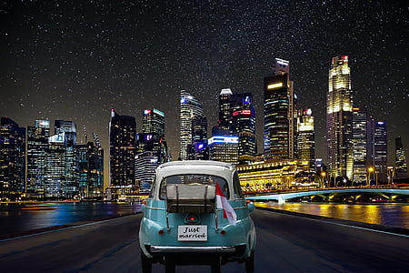 classic green and white vehicle on gray road at night thumbnail