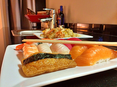 sushi food on white plate with chopsticks on top thumbnail
