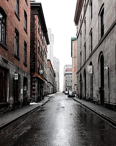 narrow road near building under white sky during daytime photography thumbnail