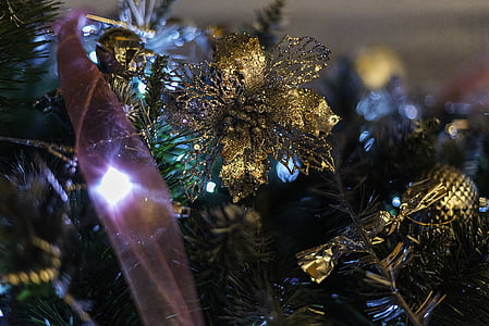 close view of gold flower ornaments on Christmas tree thumbnail