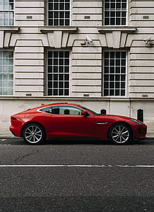 red sports coupe parked on roadside during daytime thumbnail