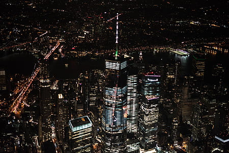 gray high-rise buildings with lights during night time thumbnail