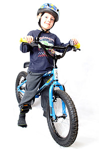 boy standing on BMX bike wearing helmet thumbnail