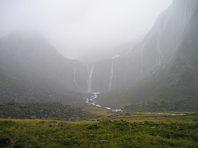 landscape photography of water falls under foggy weather thumbnail