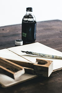 bottle filled with ink on table thumbnail