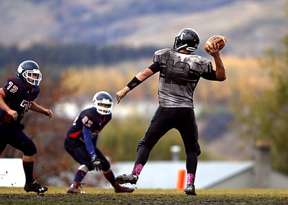 2 Football Player Running After Person Holding Football during Daytime in Shallow Focus Photography thumbnail