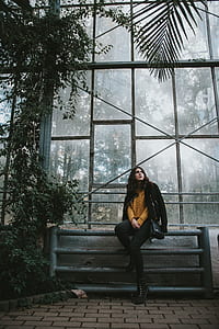 woman sitting at fence looking up thumbnail