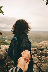 Woman Wearing Black Long-sleeved Shirt Holding Someone's Hand thumbnail
