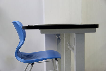 blue chair in front of black table thumbnail
