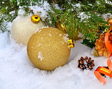 two brown and beige baubles on white snow thumbnail
