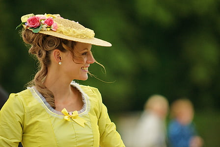 shallow focus photography of woman in yellow-green dress and hat during daytime thumbnail