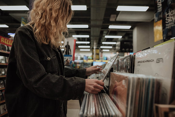 woman holding vinyl record sleeve