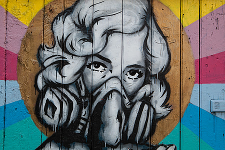 Street art depicting a woman wearing a mask captured on a wall in Shoreditch, East London. Image taken with a Canon DSLR thumbnail
