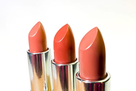closeup photography of three assorted-color lipsticks thumbnail