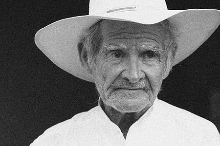grayscale photography of man with hat thumbnail
