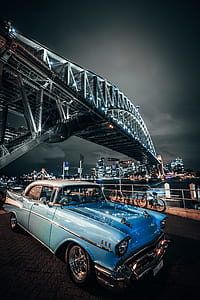 blue and white car under the bridge during nighttime thumbnail