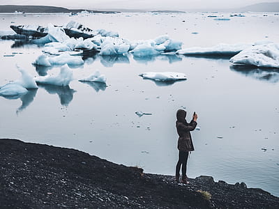 person standing beside body of water thumbnail