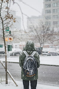 person standing near tree with snow on clothes thumbnail