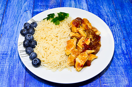 chicken dish and blueberries on white ceramic plage thumbnail