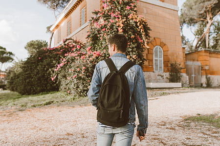 man wearing black backpack walking thumbnail