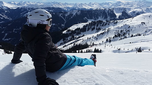 person sits on snow on hill thumbnail