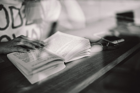 Woman reading book at coffee shop thumbnail