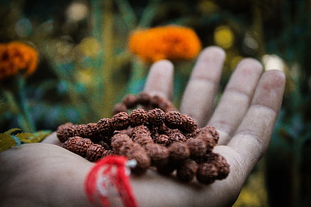 person holding prayer beads thumbnail
