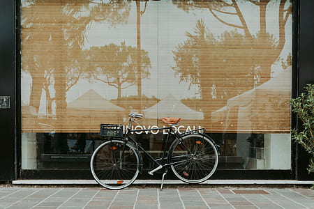 black hybrid bicycle near glass thumbnail