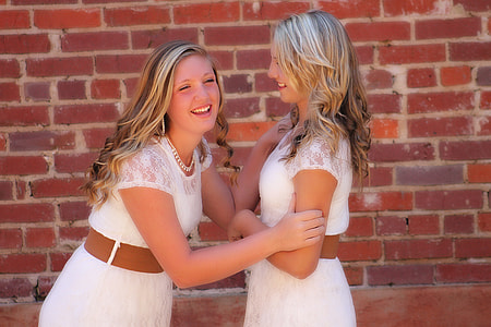 two women holding each other outdoors thumbnail